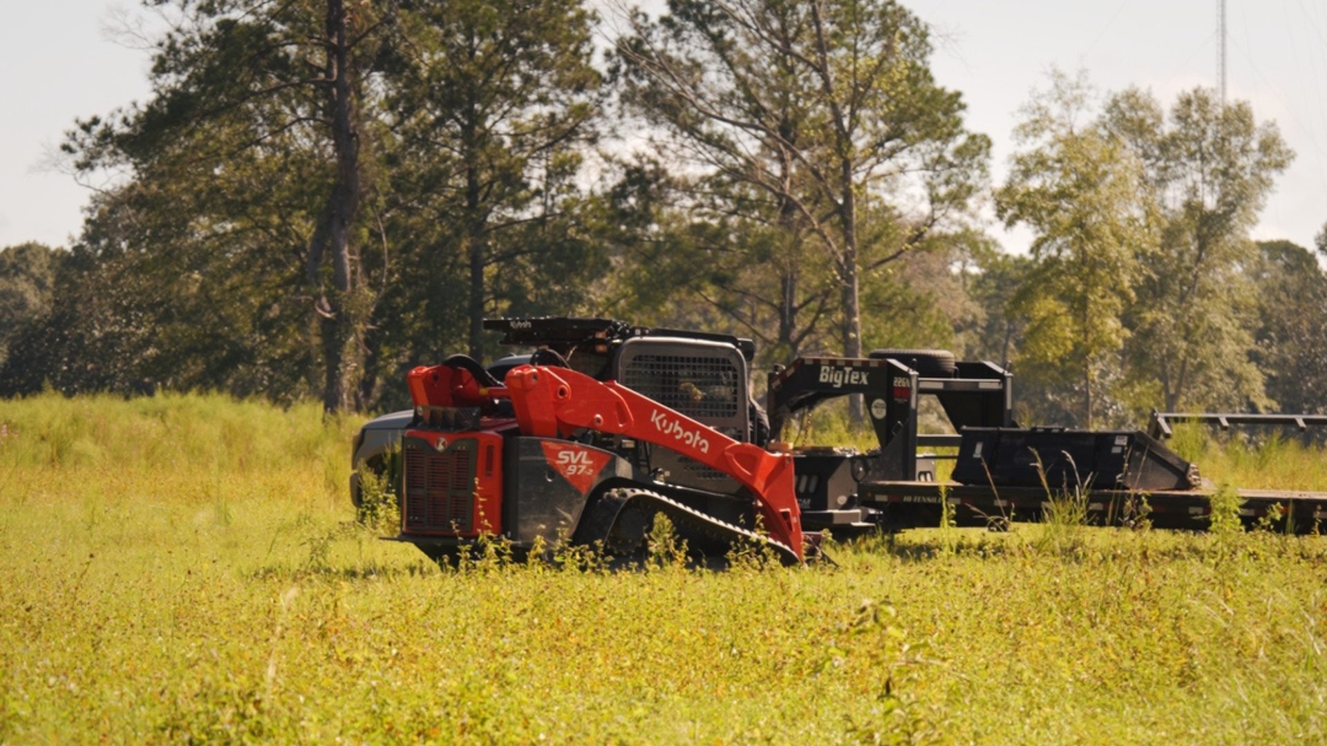 Forestry mulcher working a grassy tract.
